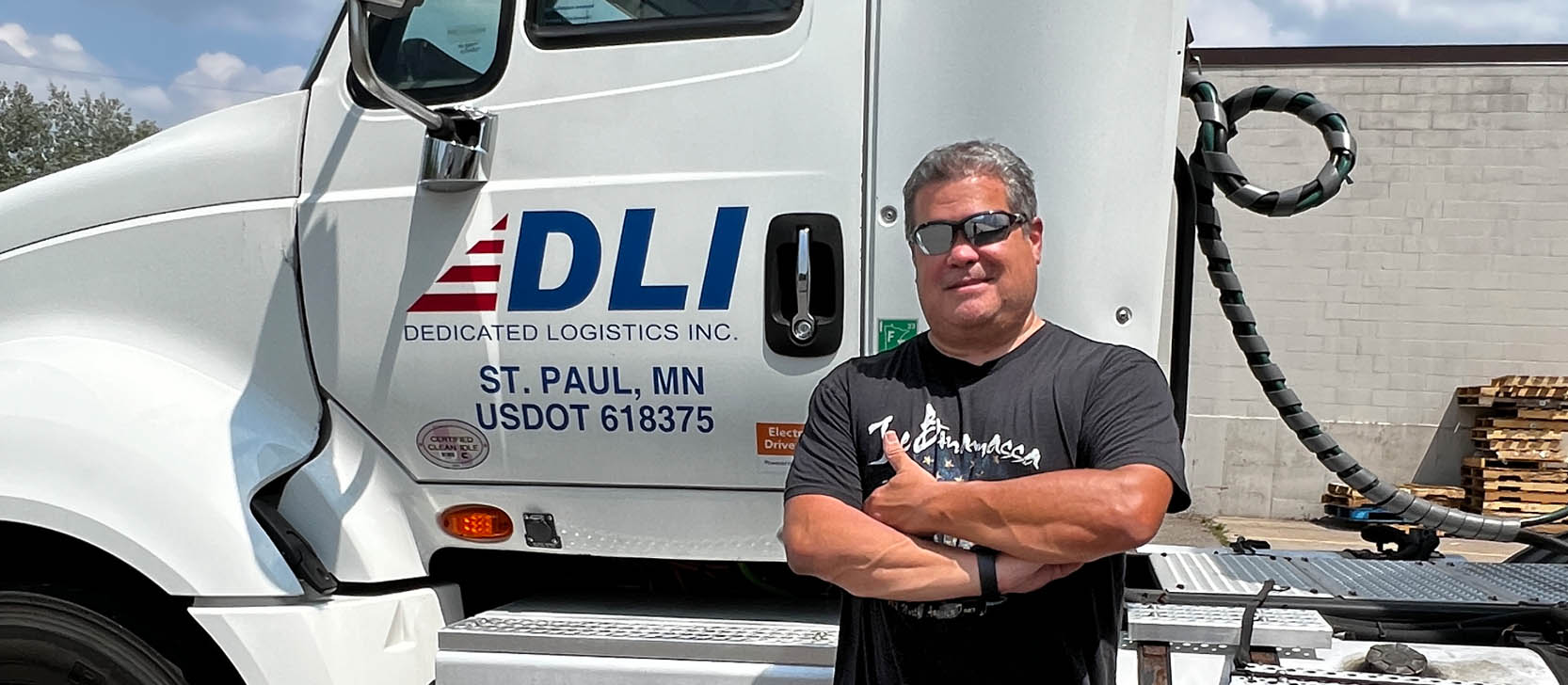 DLI driver in front of truck