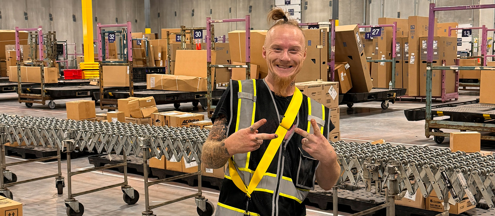 Warehouse worker smile peace sign